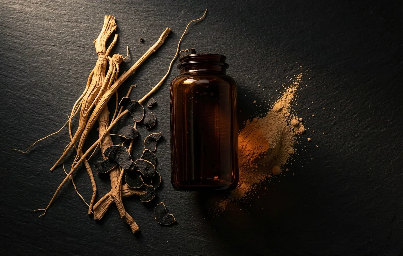 Botanical ingredients and amber supplement bottle on dark surface